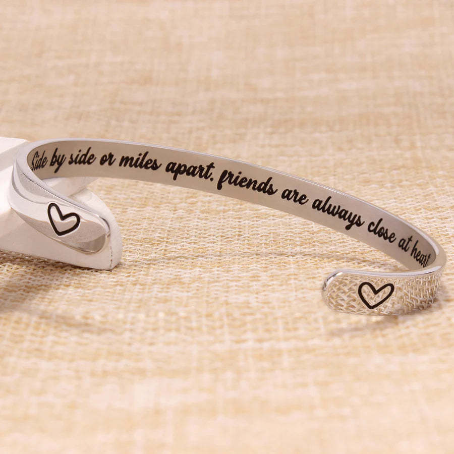 Side by side or miles apart friends are always close at heart.